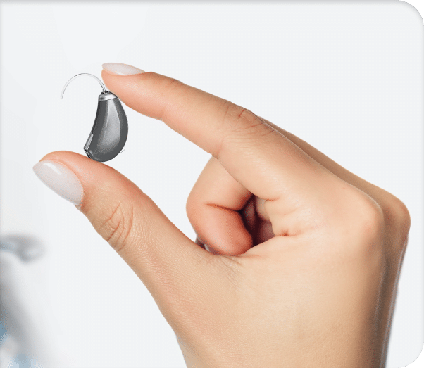 Close up of an audiologist holding a hearing aid